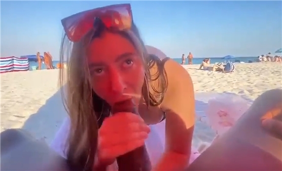Blowjob on a beach full of people