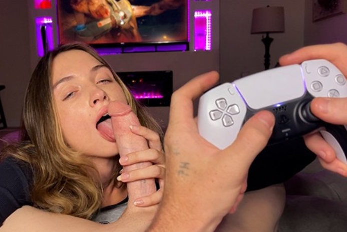 She gives her boyfriend a blowjob while playing a playstation